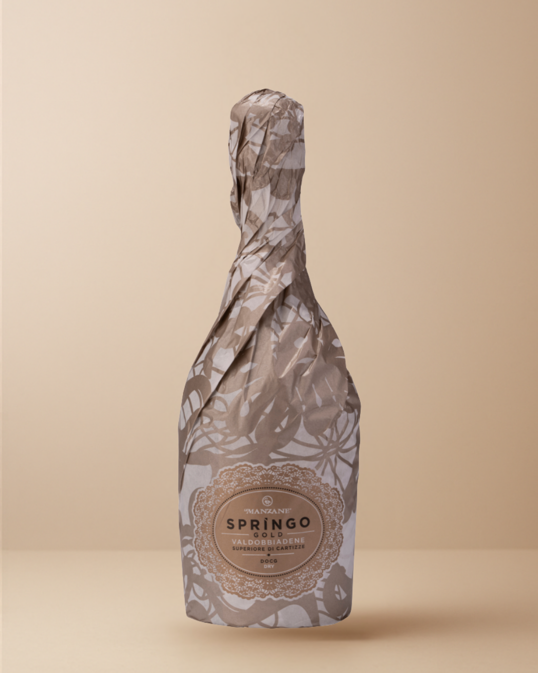 Bottle of Prosecco Cartizze wrapped in decorative paper on a beige background